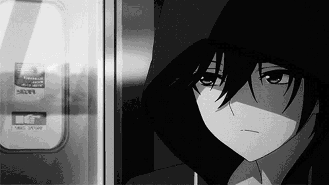 a black and white photo of a boy wearing a hood