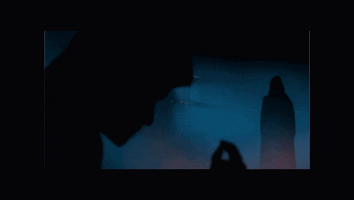 a blurry picture of a person 's face in a dark room
