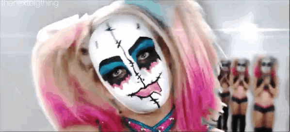 a woman with pink hair and a white face painted like a doll .