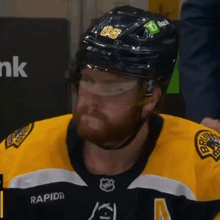 a hockey player wearing a helmet with the number 86 on it .