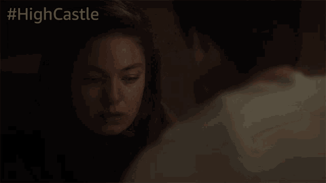 a man and a woman are looking at each other in a room .