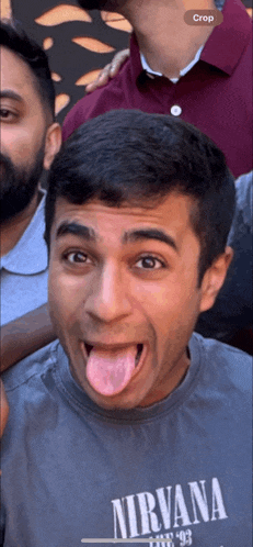 a man with his tongue out wearing a nirvana shirt