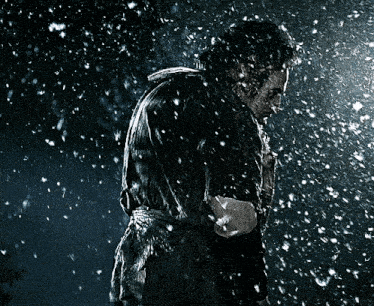 a man in a plaid shirt is in the snow