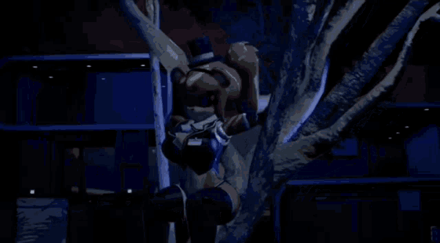 a teddy bear is climbing a tree at night .