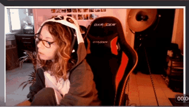a woman sits in a dxr racer gaming chair