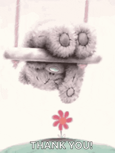 a teddy bear is hanging upside down on a swing with a flower growing out of it .