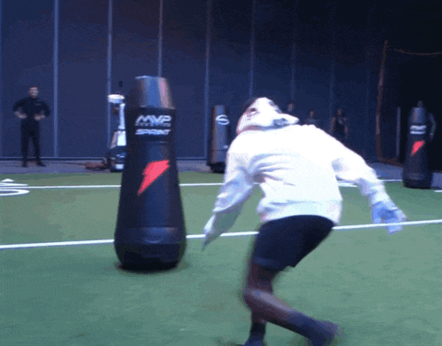 a person is jumping in front of a mvp sprint bag