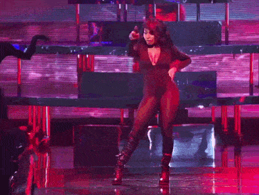 a woman with a plunging neckline is singing into a microphone