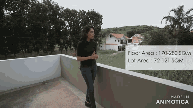 a woman standing on a balcony with the words made in animotica on the bottom