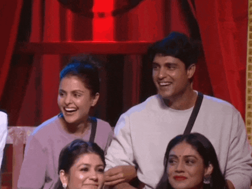 a man and a woman are sitting next to each other on a stage .