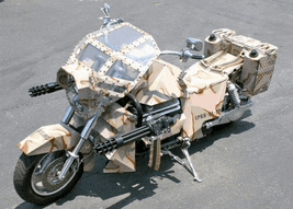 a motorcycle with a camouflage paint job and a gun on the front