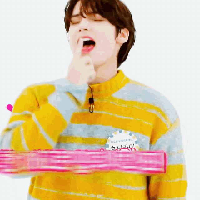 a person wearing a yellow striped sweater has a name tag that says " hyun " on it
