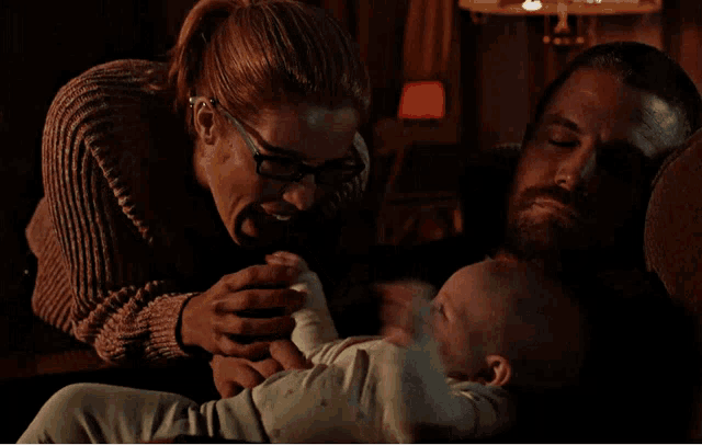 a man and woman are playing with a baby