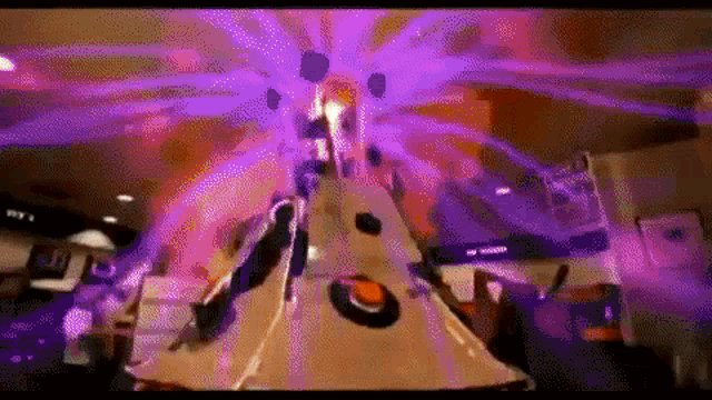 a bowling alley with a purple light coming out of the top of it