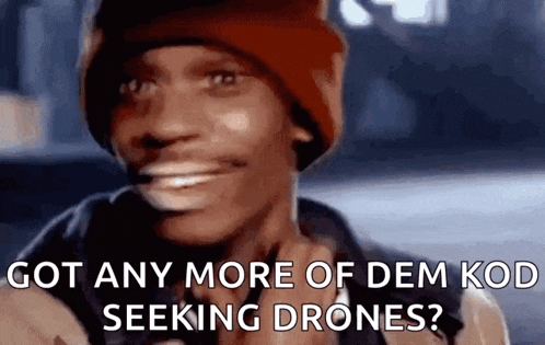 a man in a red hat is smiling and saying `` got any more of dem kod seeking drones '' .