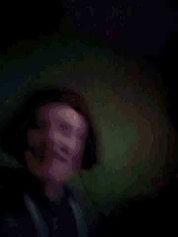 a blurred image of a person 's mouth with a green background