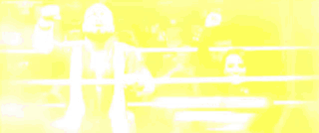 a man with a beard is standing in a wrestling ring with his arms in the air .