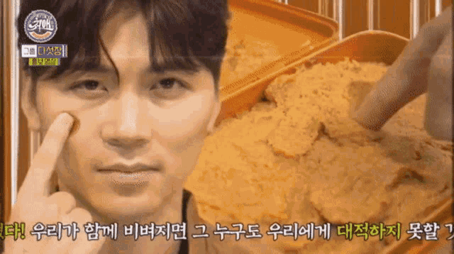 a close up of a man 's face next to a tray of food with foreign writing on it