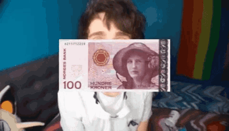 a person covering their face with a 100 kroner banknote