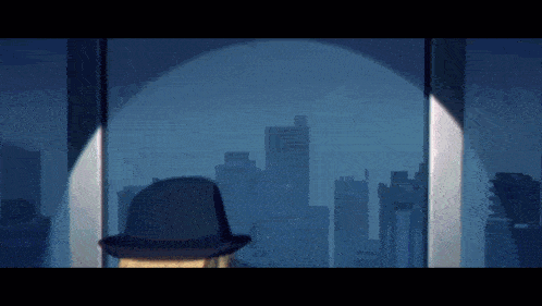 a man in a hat stands in front of a window with a city skyline in the background
