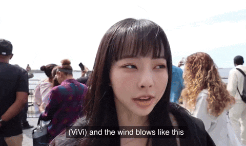 a woman says vivi and the wind blows like this in front of a crowd of people