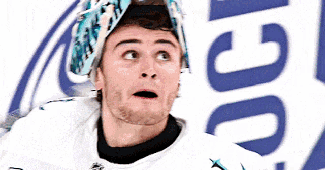 a hockey player wearing a helmet with a shark on it