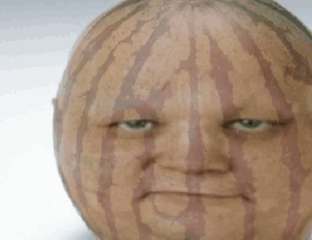 a watermelon with a man 's face drawn on it