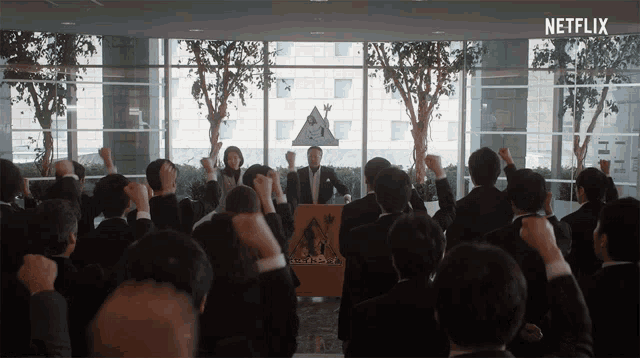 a large group of people are standing in front of a podium that says netflix on the bottom