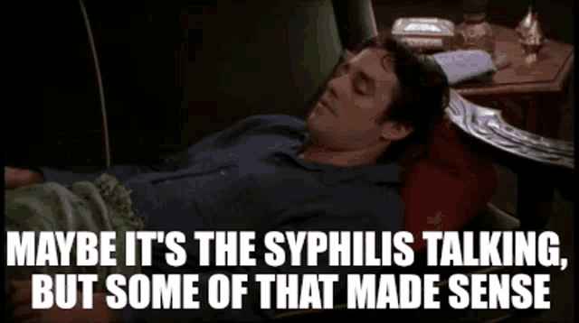 a man is laying on a couch with the words maybe it 's the syphilis talking , but some of that made sense