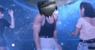 a man and a woman are dancing in a club with a shark on his head .