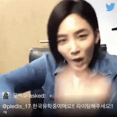 a woman in a blue shirt is being asked by a twitter user