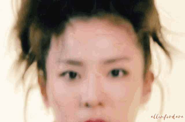 a close up of a woman 's face with the words allinfordare written below it