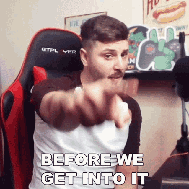 a man is pointing at the camera with the words before we get into it