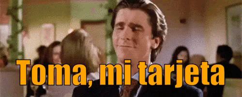 a man in a suit and tie is smiling with the words toma mi tarjeta above him