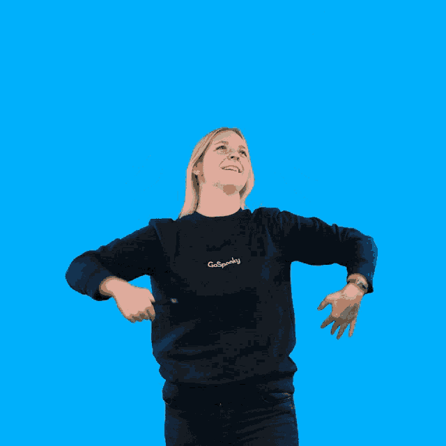 a woman wearing a black sweatshirt that says go sprinkly
