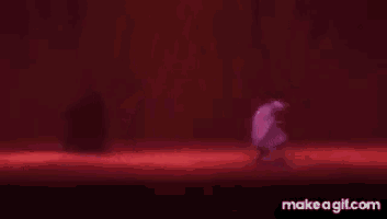 a person is dancing on a stage in a dark room .