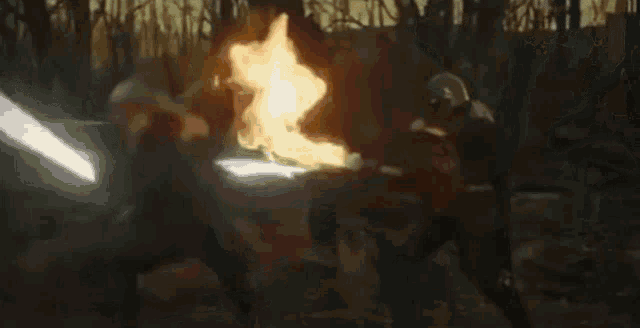 a man in a helmet is holding a sword in his hand in a forest .