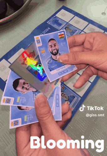 a person is holding a stack of cards with the word blooming in the corner