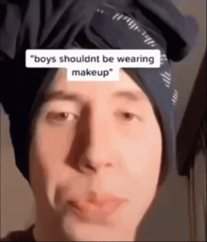 a man wearing a bandana on his head is making a funny face .