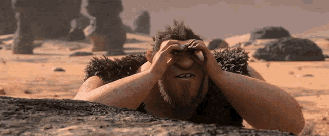 a caveman is laying on a rock in the desert