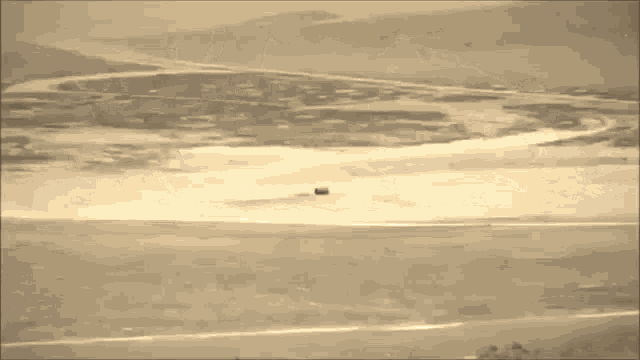 a large explosion is taking place in the sky over a desert