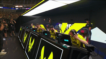 a group of people are sitting in front of computer monitors with a sign that says ' a ' on it