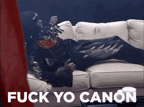 a person is laying on a couch with the words `` fuck yo canon '' written on the bottom .