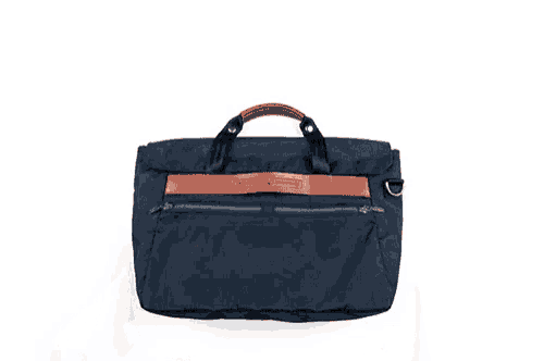 a person is holding a blue backpack with a brown leather handle that says ' mandarina bartoli ' on it