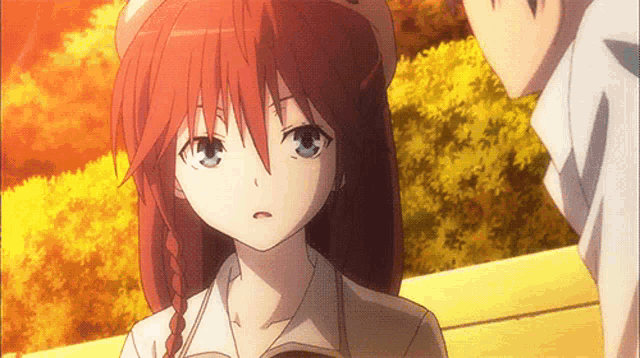 a girl with red hair is standing next to a boy