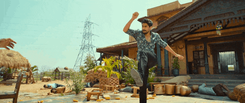 a man is kicking in front of a building that says ' cafe ' on the front