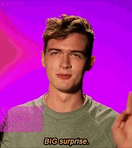 a man in a green shirt says big surprise on a purple background
