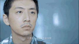 a close up of a man 's face with chinese writing in the background