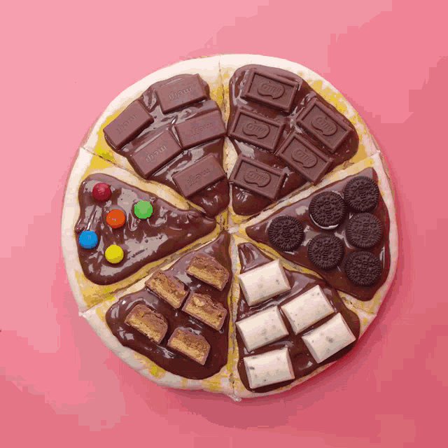 a pizza covered in different types of chocolate including m & m 's and oreos