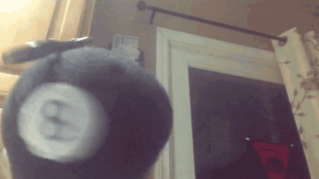 a stuffed animal with the letter h on it 's head